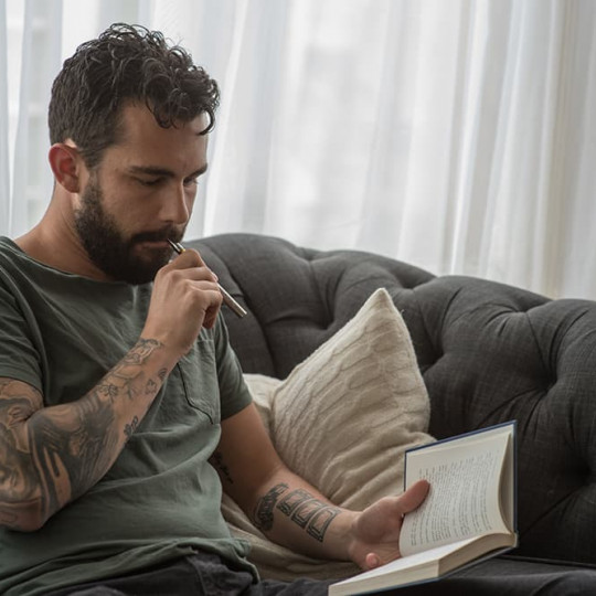 Man vaping on a couch