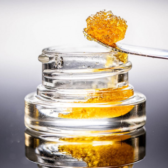 Live Resin Dab Sauce Cannabis Oil Macro with Jar Isolated Legal California Extracts from Weed Dispensary - Shutterstock