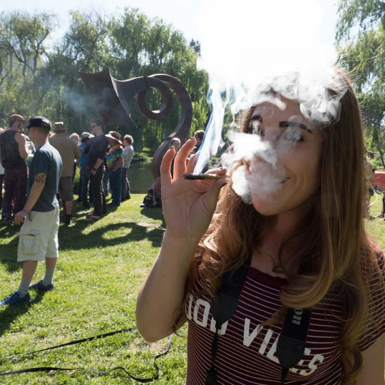 young woman taking a hit of cannabis