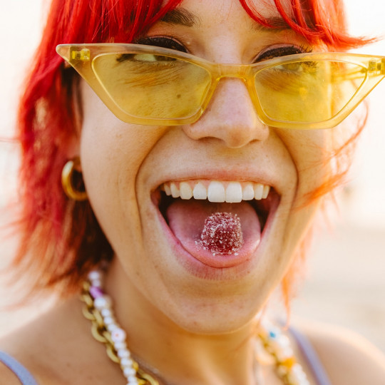 Young woman enjoying a cannabis gummy