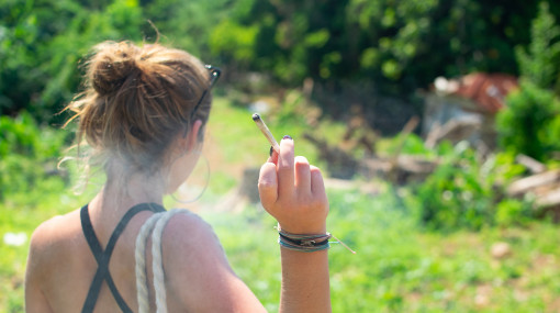 A young woman with a cannabis cigarette