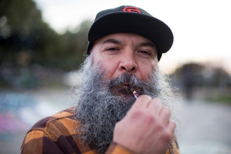 Man in San Francisco Giants cap vaping