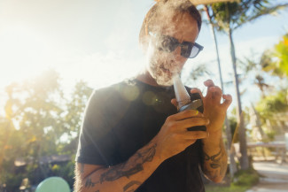 A man smoking terp sauce in a dab rig